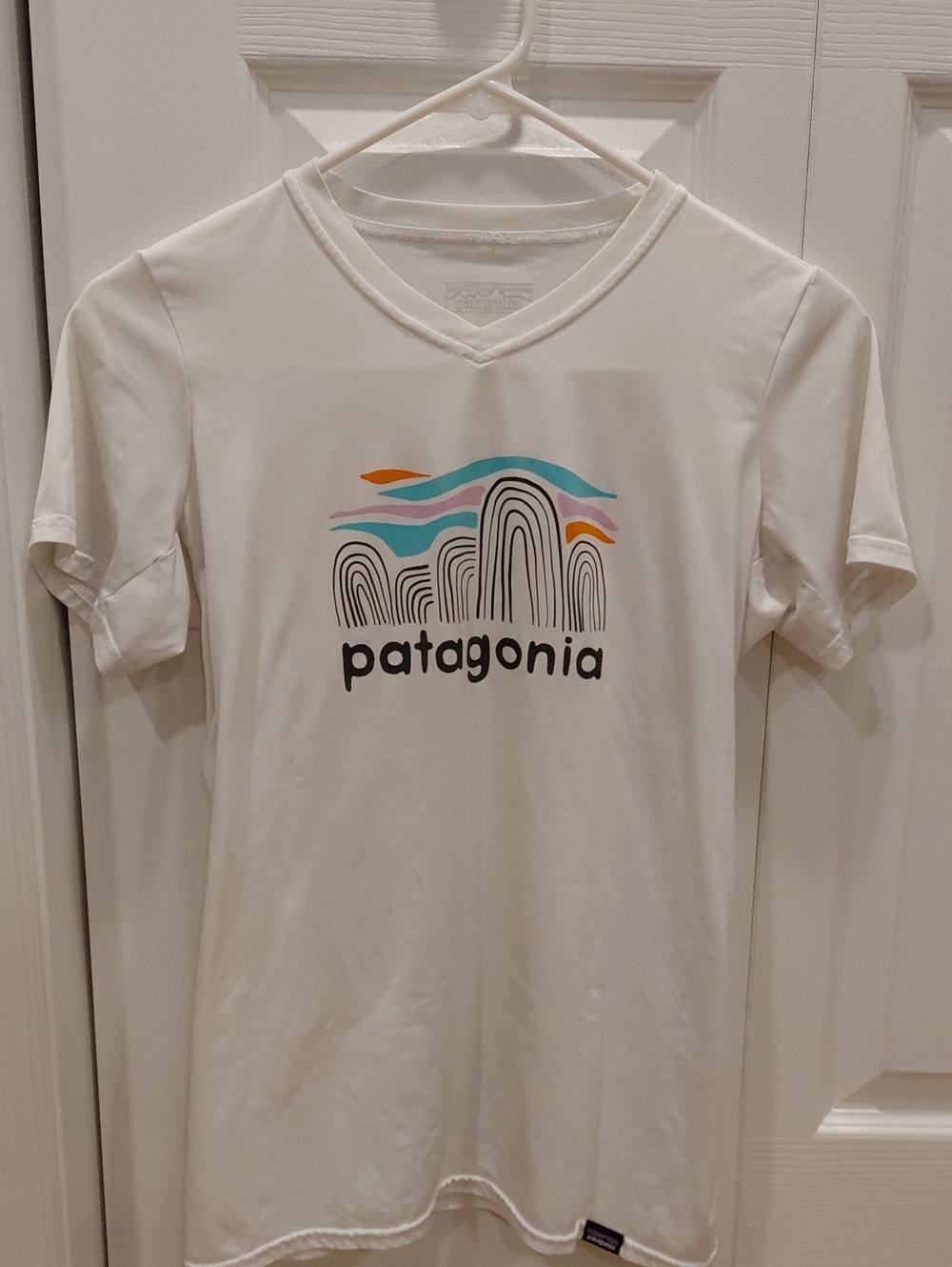Patagonia White V‑Neck Tee with Multicolor Wave Design